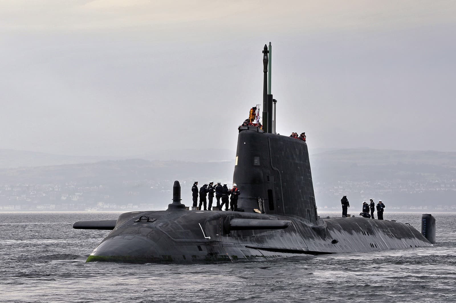 Real photograph of HMS Astute (S119), showing the surfaced Astute-class submarine, bow, sail and masts.
