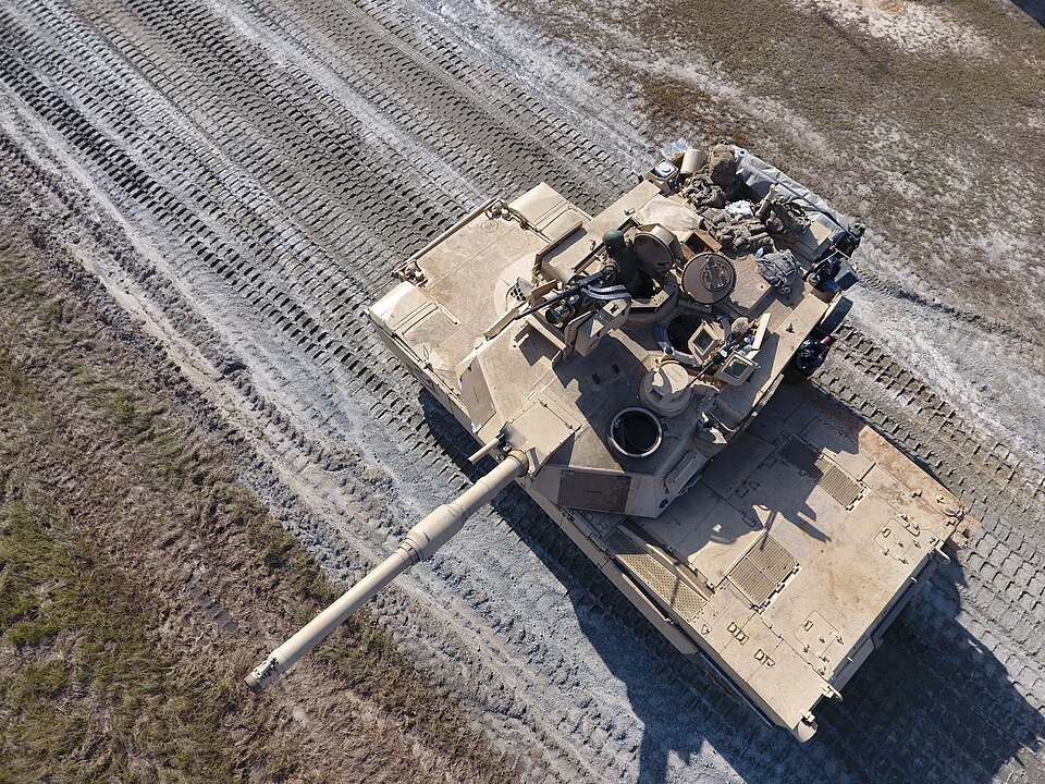 Overhead photograph of an M1A2 Abrams tank on sandy ground