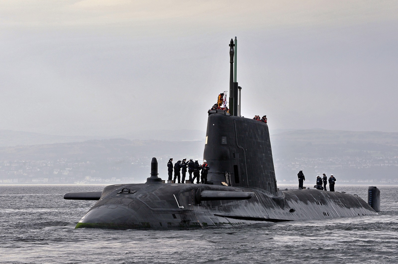 Real photograph of HMS Astute (S119), showing the surfaced Astute-class submarine, bow, sail and masts.